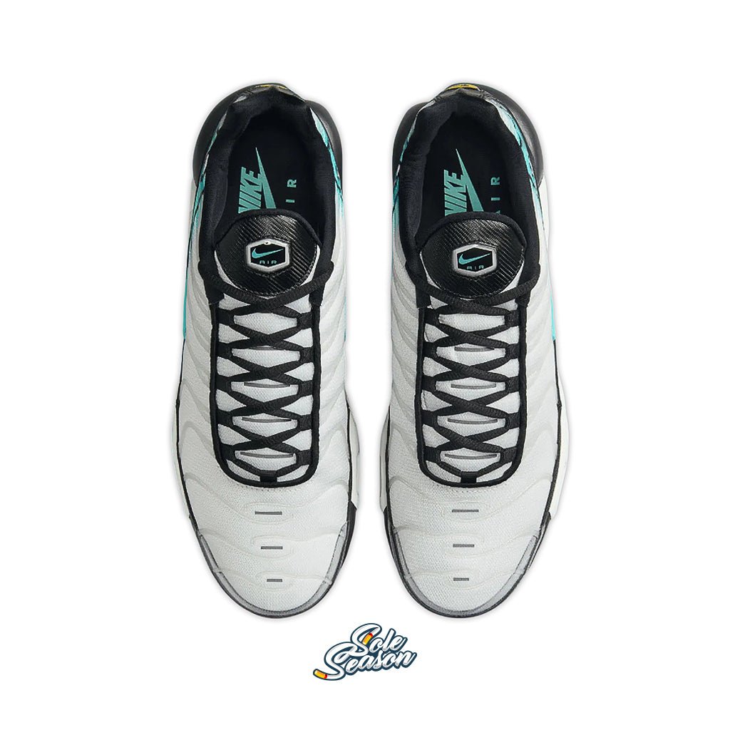 Top-down view of the Nike TN Mercurial Vapour sneakers in white, black, and teal with signature black laces and Nike Air branding on the tongue.